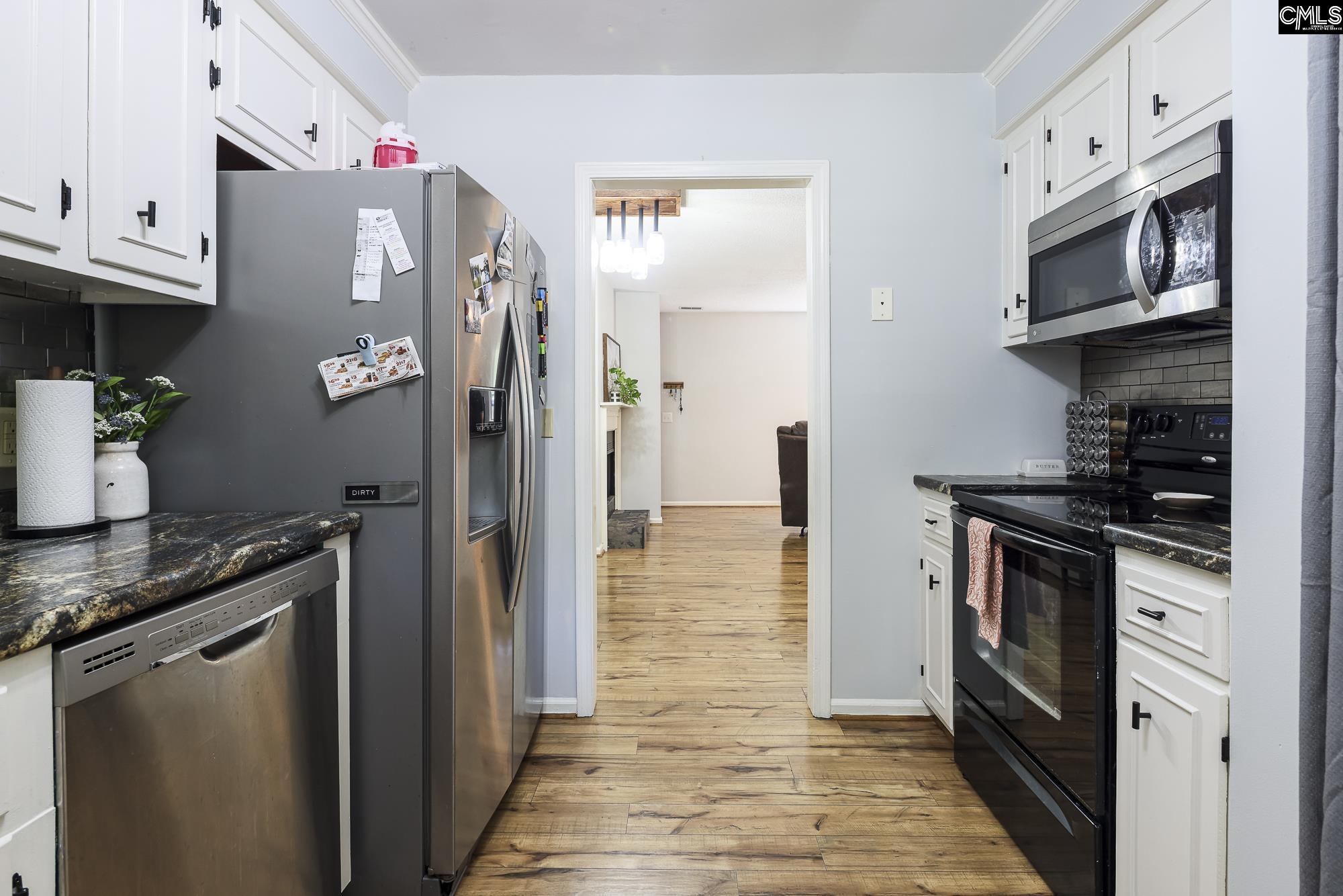 152 Thames Valley Court Irmo, SC 29063 - Photo 19 of 32 a kitchen with stainless steel appliances granite countertop a refrigerator a stove and a sink