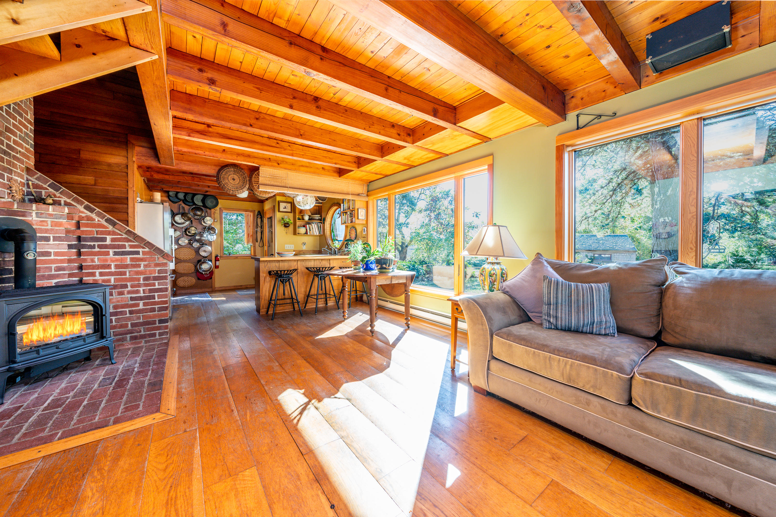 80 Peace Valley Road Wellfleet, MA 02667 - Photo 12 of 52 a living room with patio furniture and a fireplace