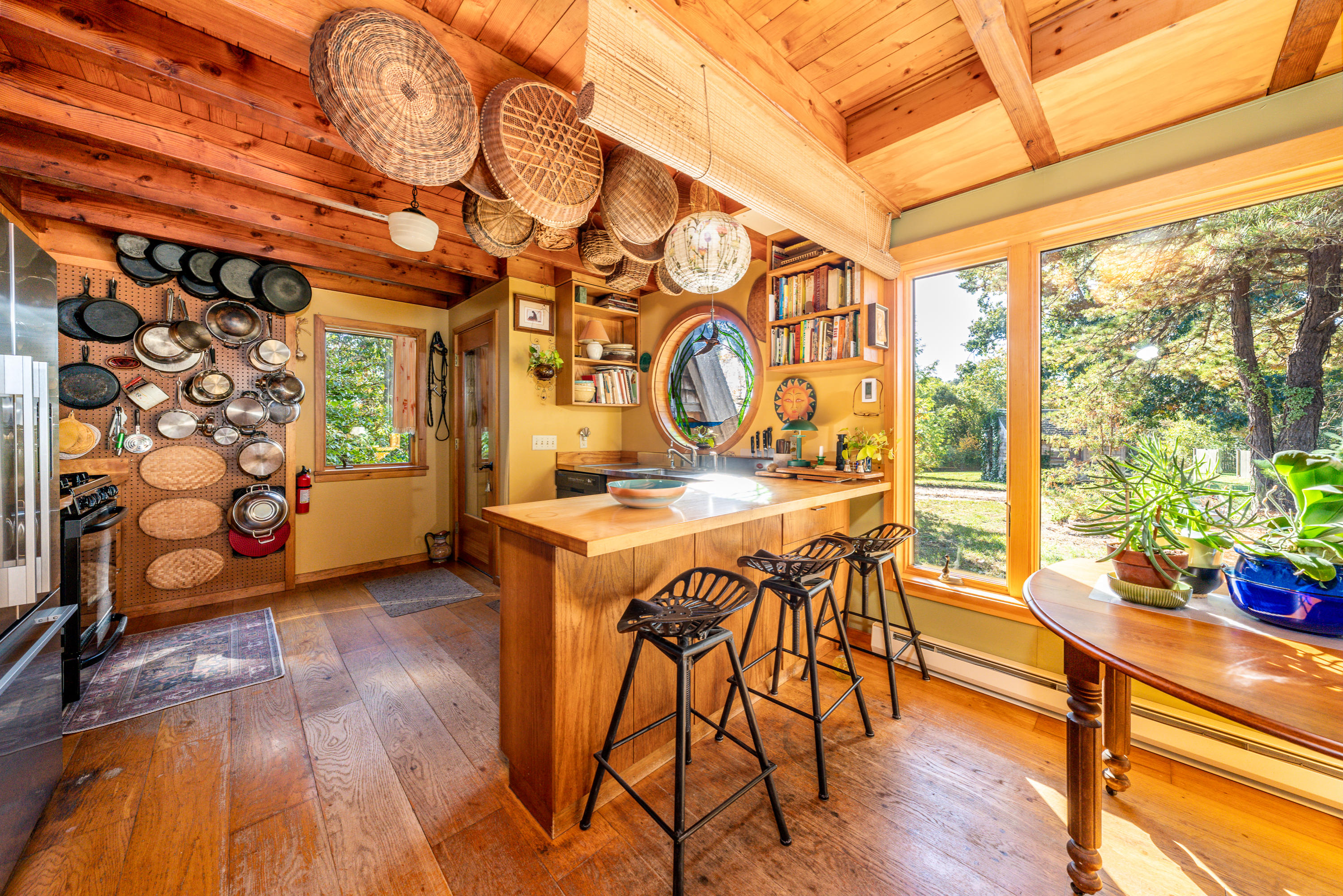 80 Peace Valley Road Wellfleet, MA 02667 - Photo 15 of 52 a view of a dining room with furniture and wooden floor