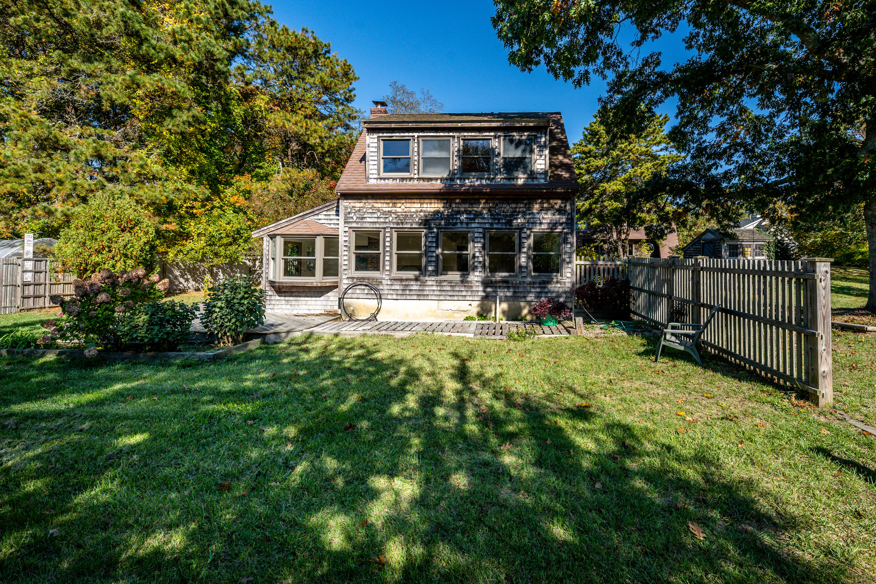 80 Peace Valley Road Wellfleet, MA 02667 - Photo 32 of 52 a front view of a house with a yard table and chairs