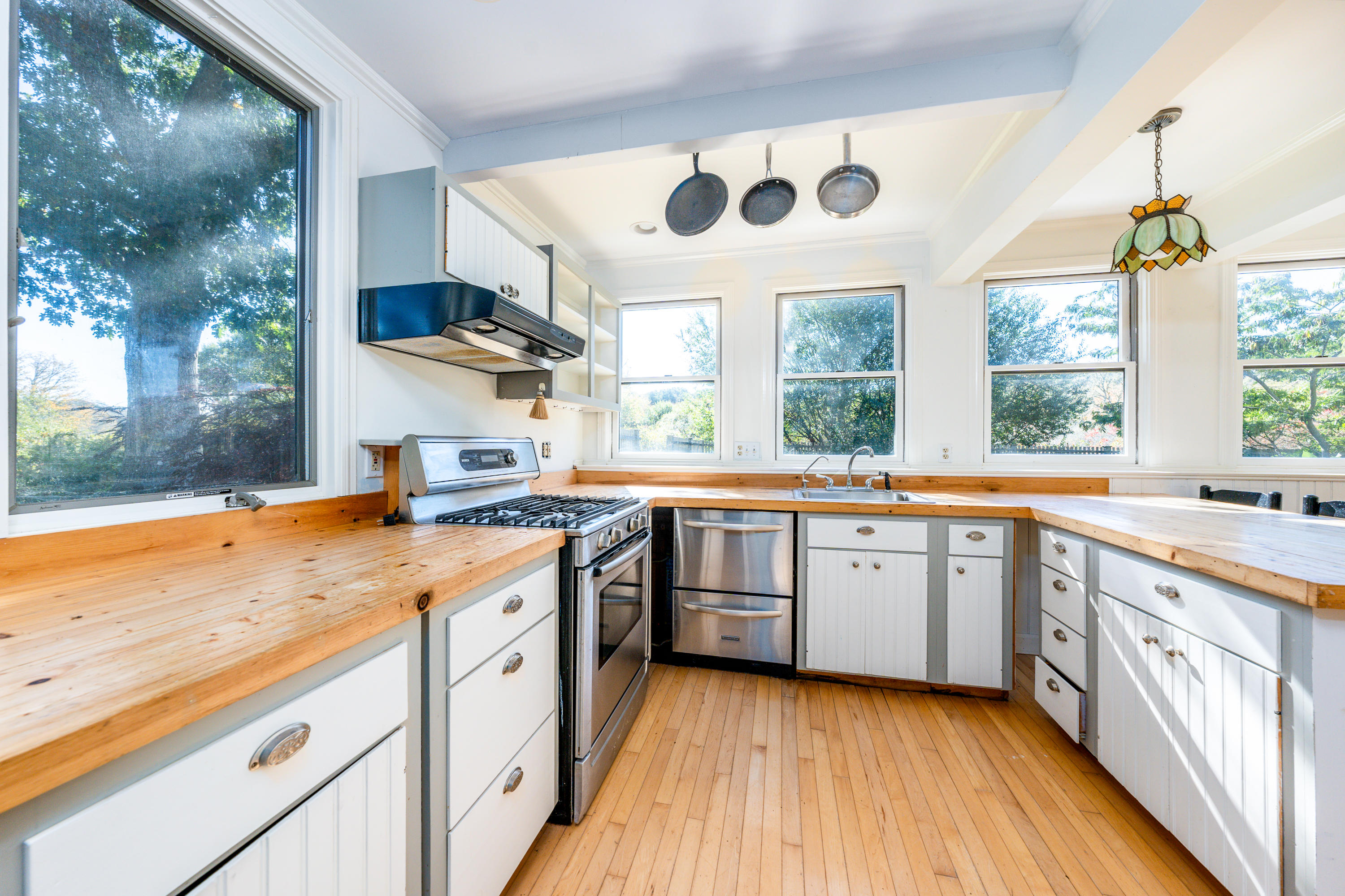 80 Peace Valley Road Wellfleet, MA 02667 - Photo 36 of 52 a kitchen with stainless steel appliances granite countertop a stove a sink and a large window