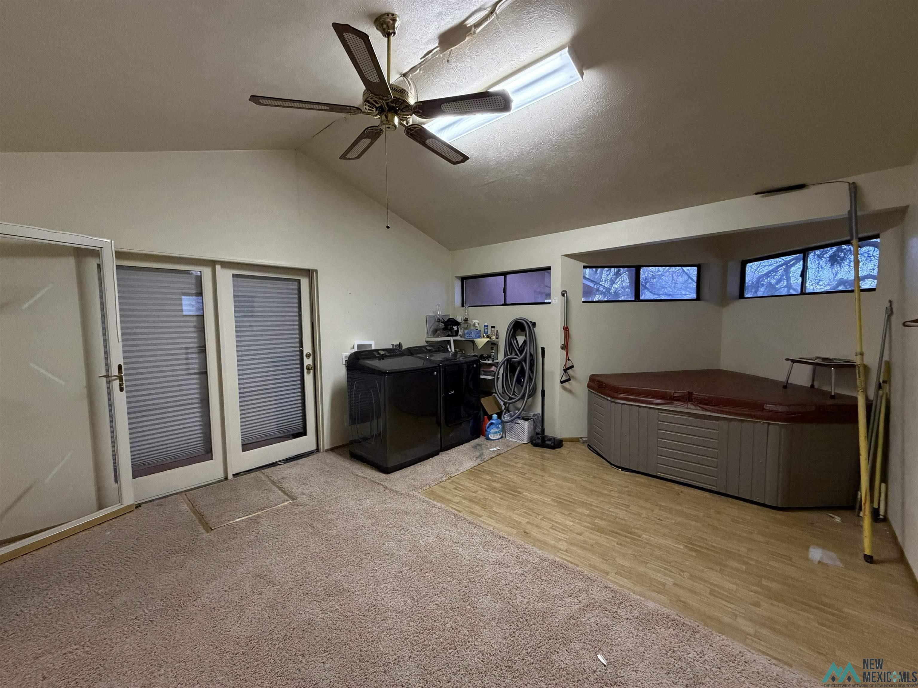 2001 East Derrick Road Carlsbad, NM 88220 - Photo 79 of 84 Laundry area featuring a ceiling fan, washer and clothes dryer, and light wood-type flooring