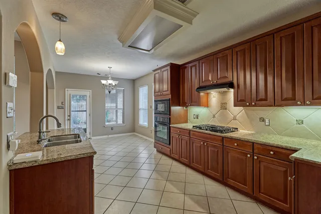 a large spacious bathroom with a granite countertop sink a mirror and shower