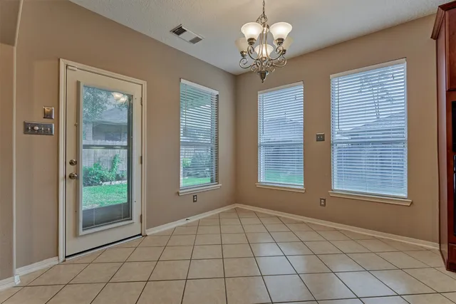 a view of kitchen with granite countertop cabinets and window