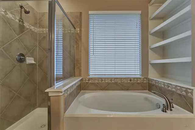 a spacious bathroom with a double vanity sink a large mirror and a shower