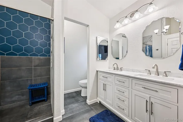 a bathroom with a double vanity sink mirror and