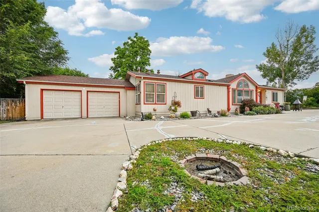 a front view of a house with a yard and outdoor seating