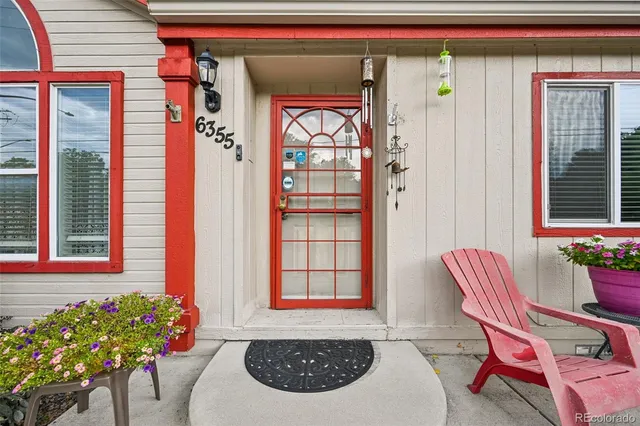 a front view of a house with outdoor seating and windows