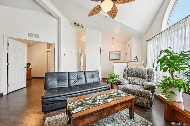 a living room with furniture and a potted plant