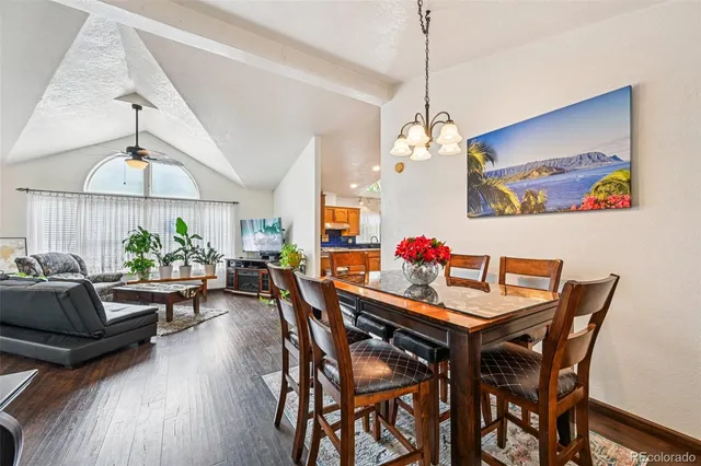 a view of a dining room with furniture wooden floor and a chandelier