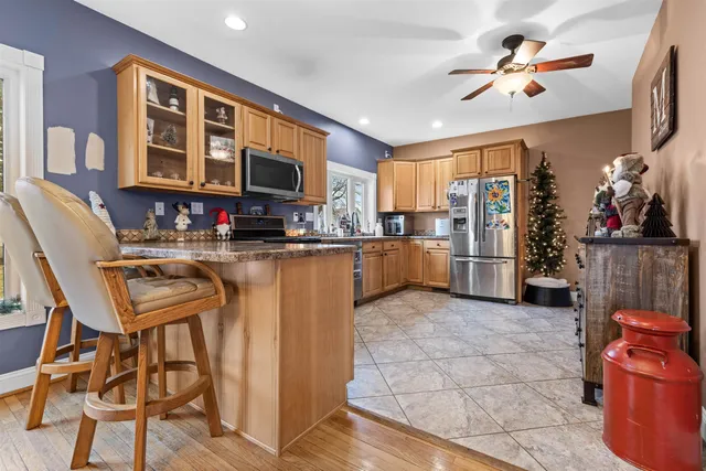 a dining room with furniture a chandelier and wooden floor