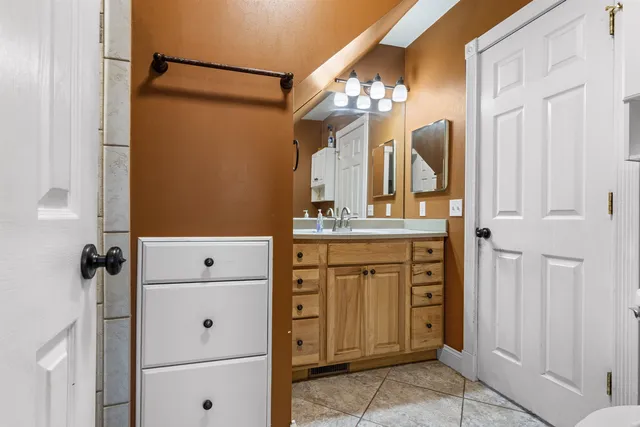 a bedroom with a bed and a table in it