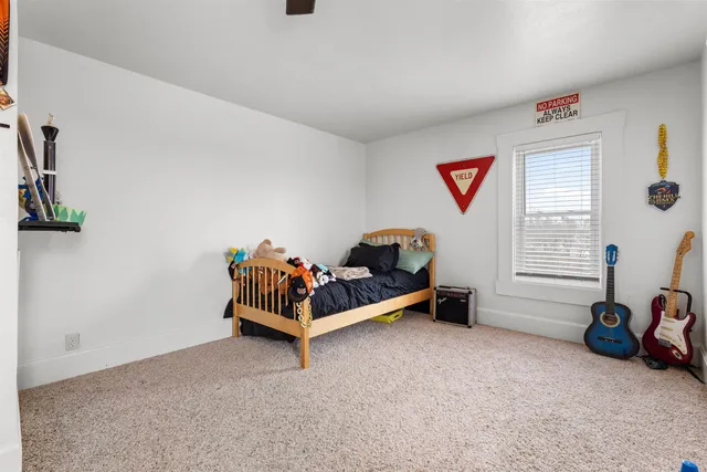 a bedroom with two beds and painting on the wall