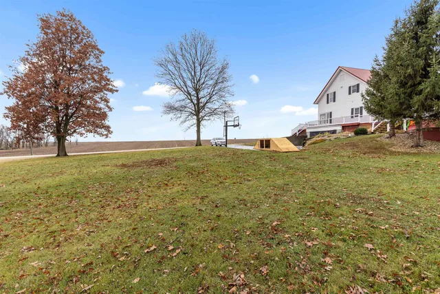 a backyard of a house with table and chairs