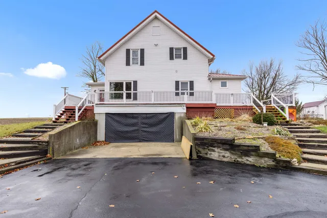 a view of a roof deck with table and chairs with wooden floor and fence
