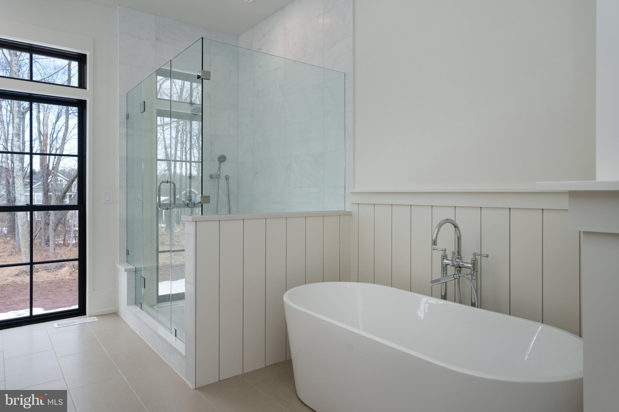 241 Carter Road Princeton, NJ 08540 - Photo 17 of 28 a white bath tub sitting in a bathroom and shower