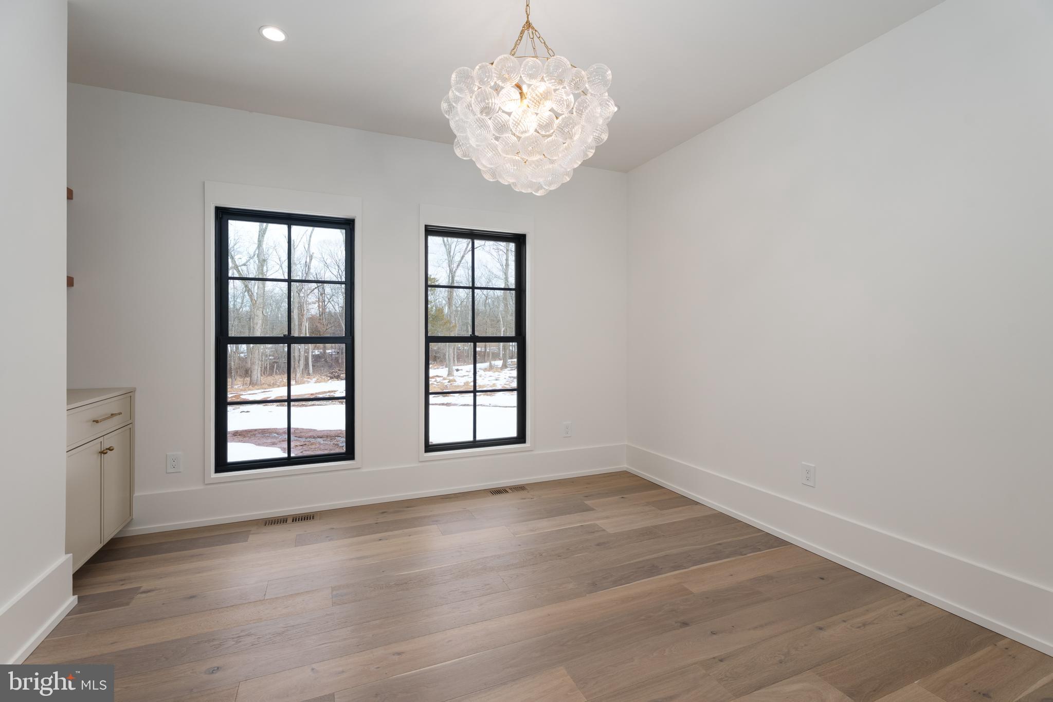 241 Carter Road Princeton, NJ 08540 - Photo 18 of 28 an empty room with wooden floor and windows