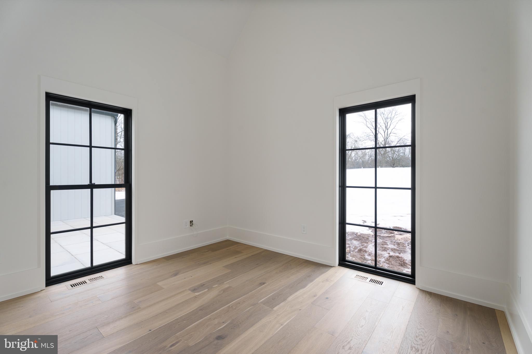 241 Carter Road Princeton, NJ 08540 - Photo 19 of 28 an empty room with wooden floor and windows