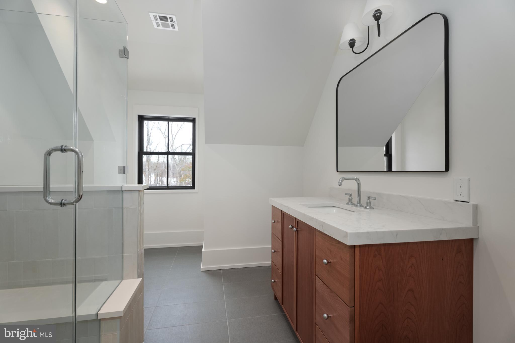 241 Carter Road Princeton, NJ 08540 - Photo 28 of 28 a bathroom with a sink a vanity and mirror