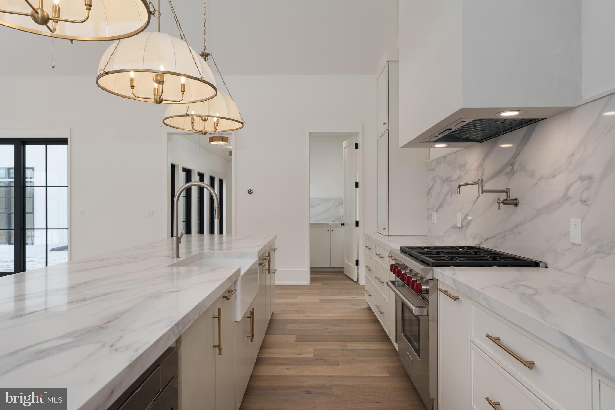 241 Carter Road Princeton, NJ 08540 - Photo 9 of 28 a kitchen with kitchen island stainless steel appliances a table chairs window and wooden floor