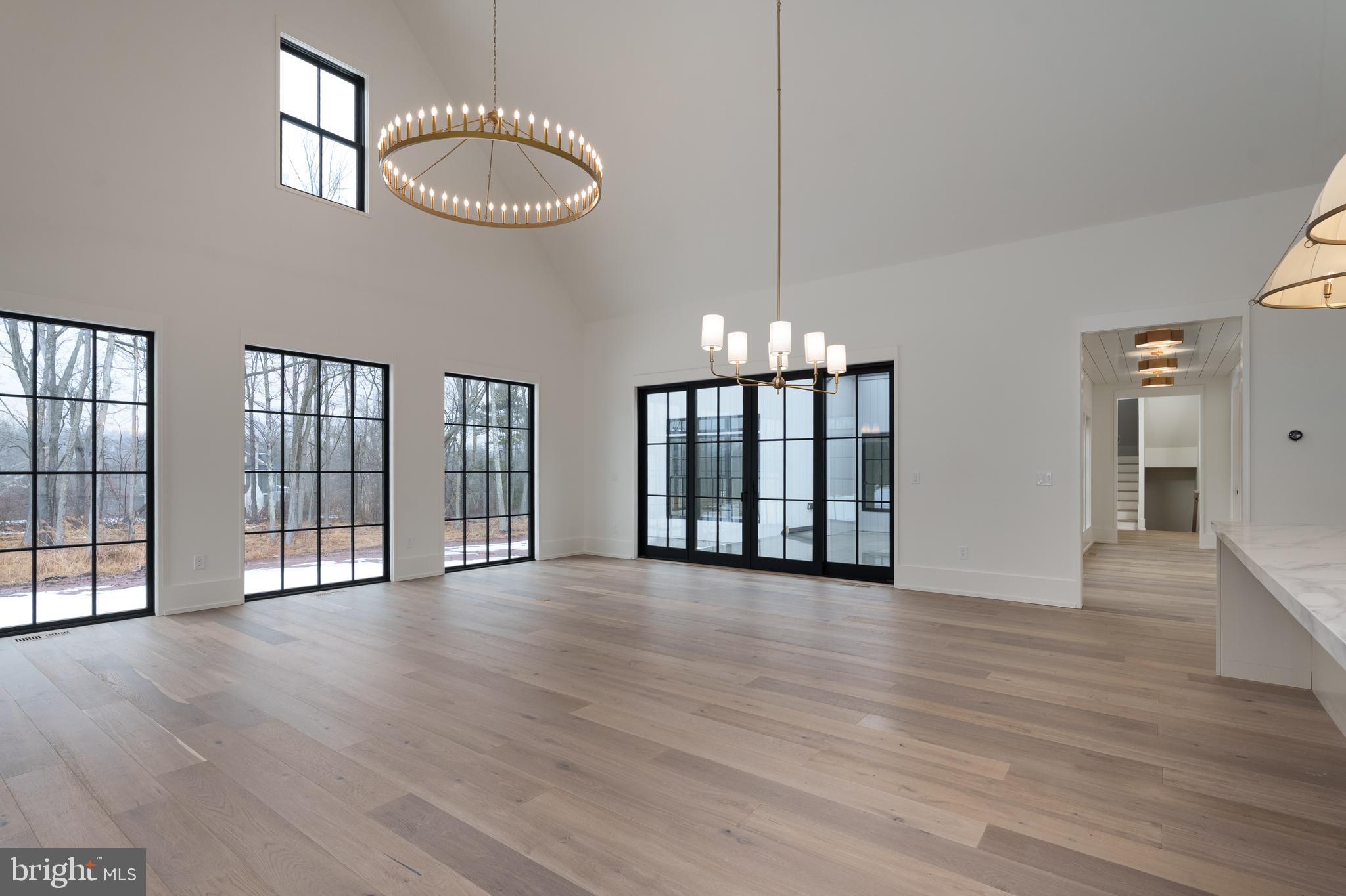 241 Carter Road Princeton, NJ 08540 - Photo 10 of 28 an empty room with wooden floor and windows