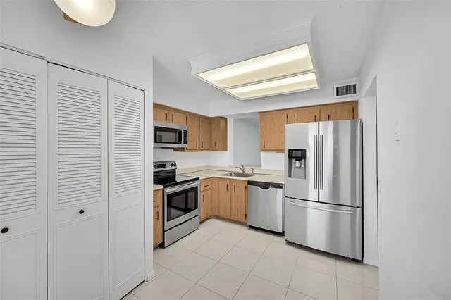 a kitchen with granite countertop white cabinets and sink