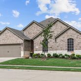 a view of a house with a yard and large tree