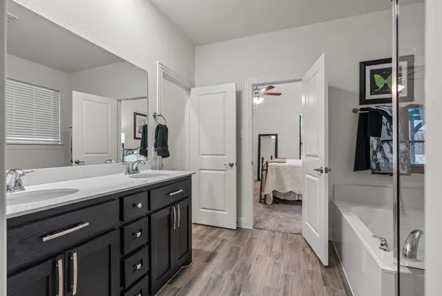 a spacious bathroom with a double vanity sink and a mirror