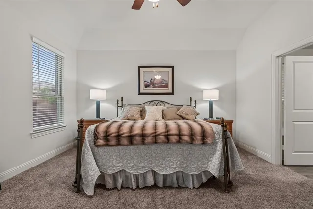 a bedroom with a bed and a night stand