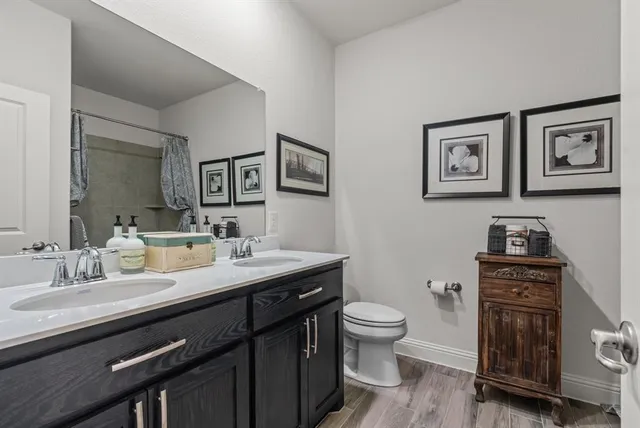 a bathroom with a toilet a sink and mirror
