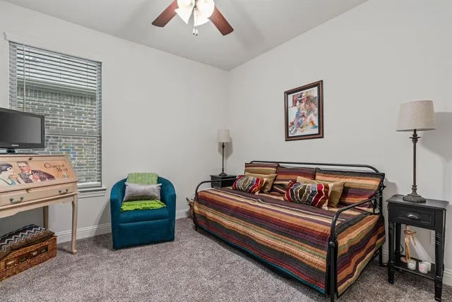 a bedroom with a bed and a television