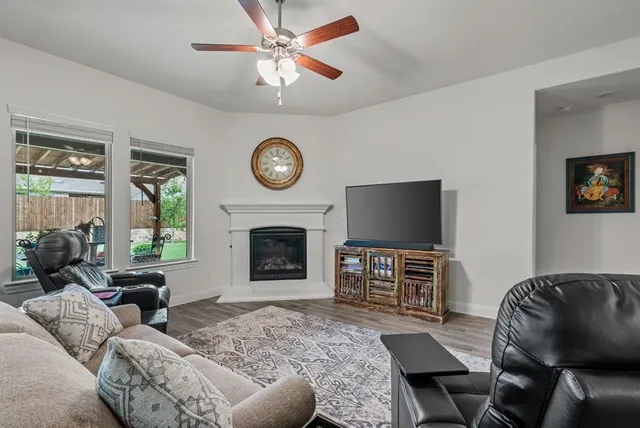 a living room with furniture a fireplace and a flat screen tv