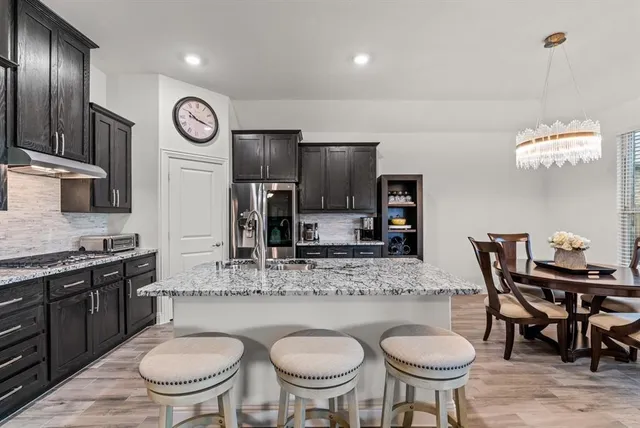 a kitchen with a dining table and chairs