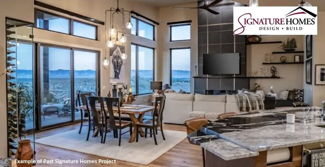 a view of a living room with a floor to ceiling window and kitchen