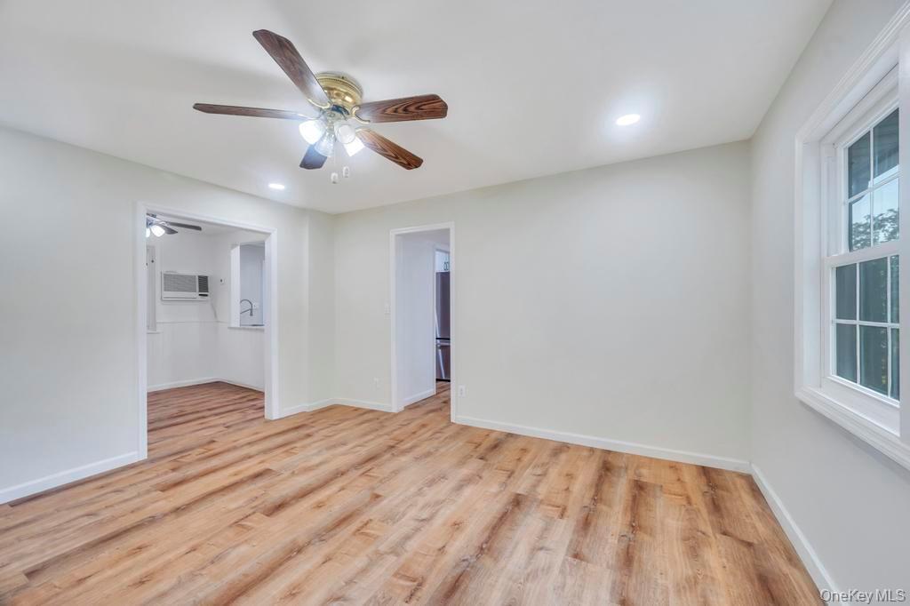 815 Udall Road West Islip, NY 11795 - Photo 12 of 45 Unfurnished room with light wood finished floors, ceiling fan, and recessed lighting