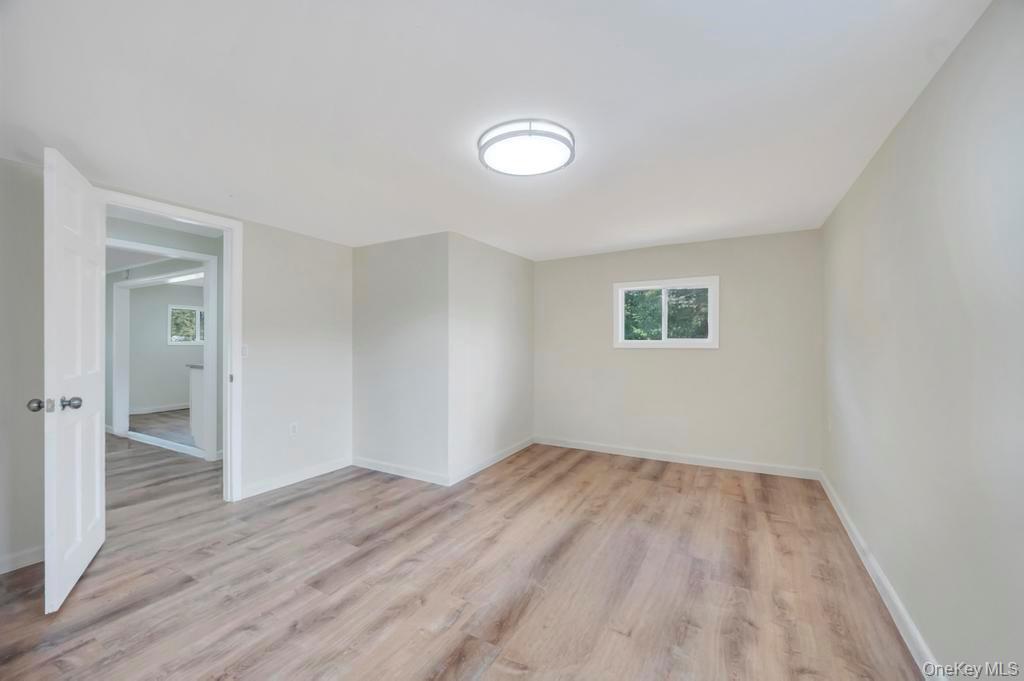 815 Udall Road West Islip, NY 11795 - Photo 21 of 45 Empty room featuring light wood-style floors and baseboards