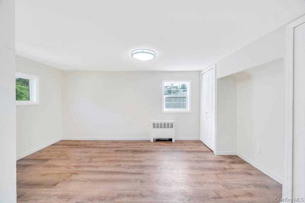 815 Udall Road West Islip, NY 11795 - Photo 23 of 45 Below grade area with light wood finished floors and radiator