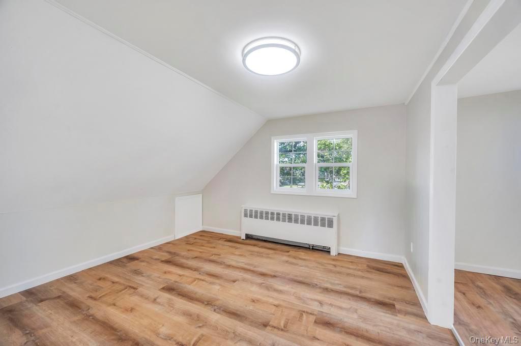 815 Udall Road West Islip, NY 11795 - Photo 29 of 45 Bonus room featuring radiator heating unit, light wood-type flooring, and lofted ceiling