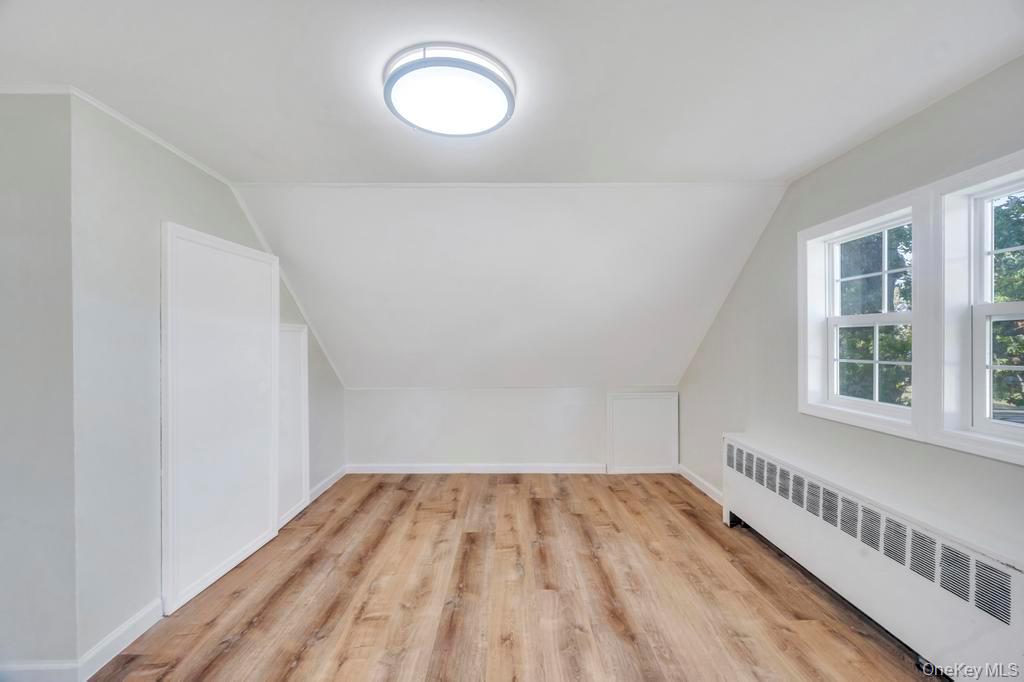 815 Udall Road West Islip, NY 11795 - Photo 30 of 45 Bonus room with radiator heating unit, lofted ceiling, and light wood-style flooring