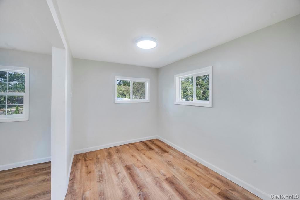 815 Udall Road West Islip, NY 11795 - Photo 31 of 45 Unfurnished room with light wood-style floors and baseboards