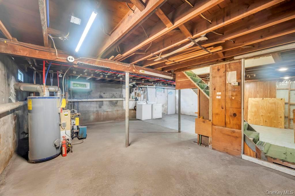 815 Udall Road West Islip, NY 11795 - Photo 38 of 45 Basement featuring water heater and washing machine and clothes dryer
