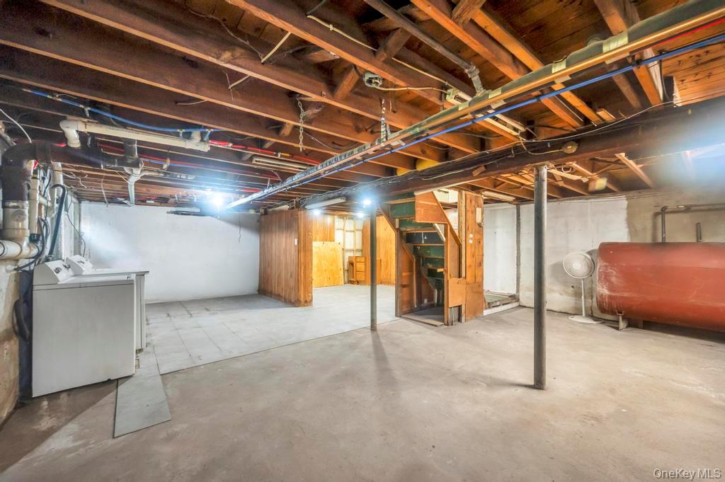 815 Udall Road West Islip, NY 11795 - Photo 39 of 45 Unfinished below grade area with washer / dryer, stairs, and heating fuel