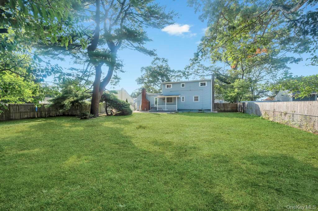 815 Udall Road West Islip, NY 11795 - Photo 45 of 45 Rear view of house with a fenced backyard