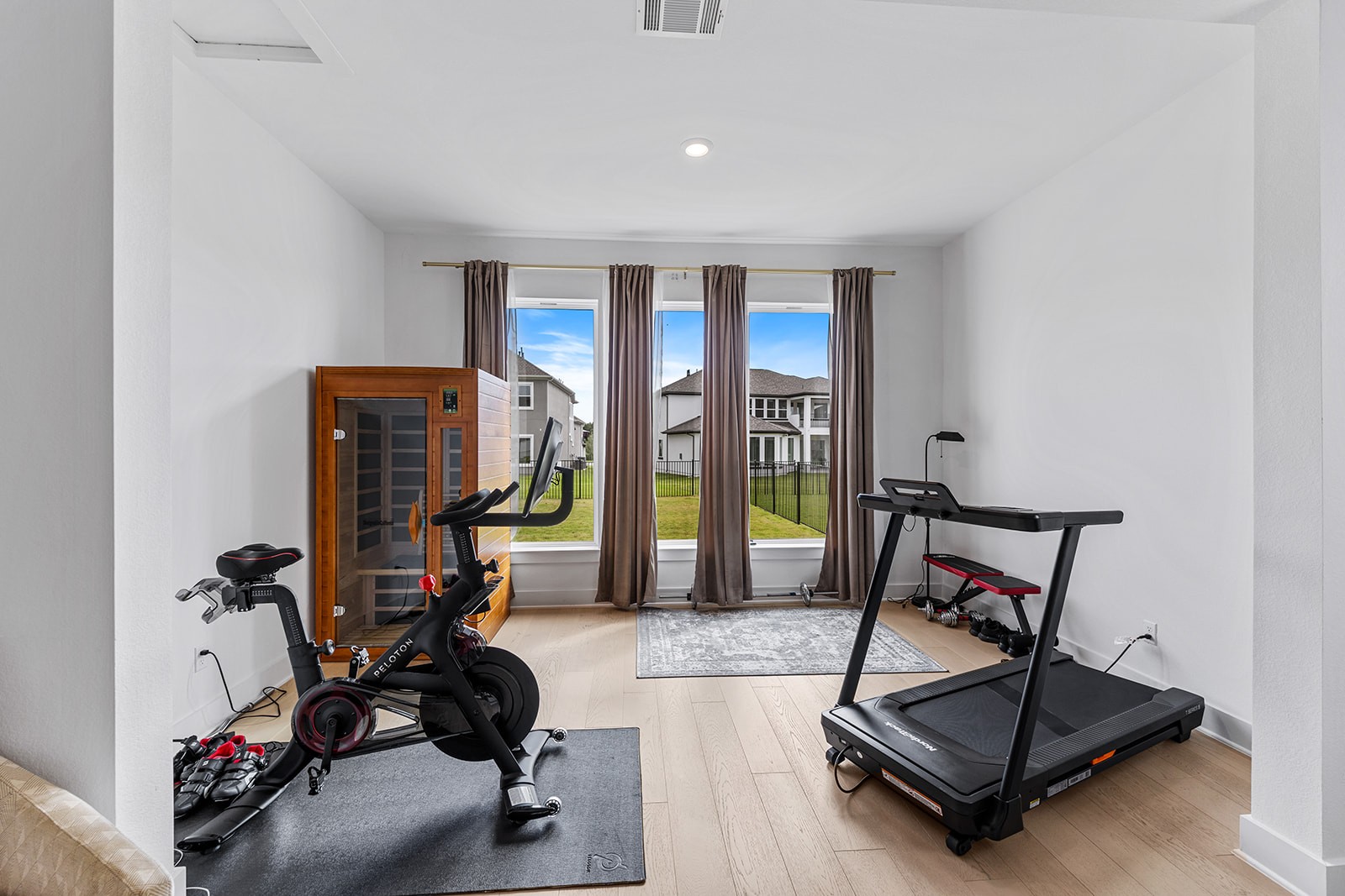 2905 Canto Trace Leander, TX 78641 - Photo 16 of 40 a living room with furniture gym equipment and a floor to ceiling window
