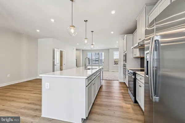 a large kitchen with stainless steel appliances lots of counter space