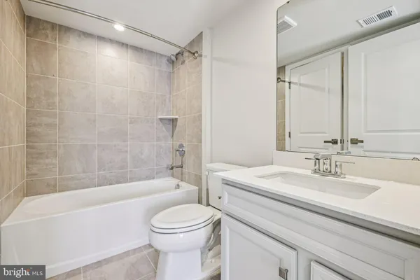 a bathroom with a sink a toilet and a bathtub