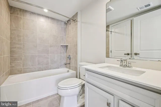 a bathroom with a sink a toilet and a bathtub