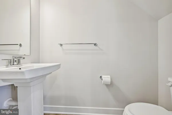 a bathroom with a sink a toilet and mirror