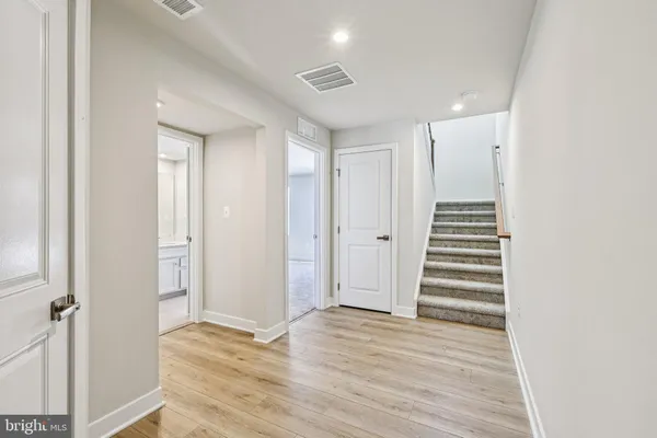 a view of a hallway with wooden floor