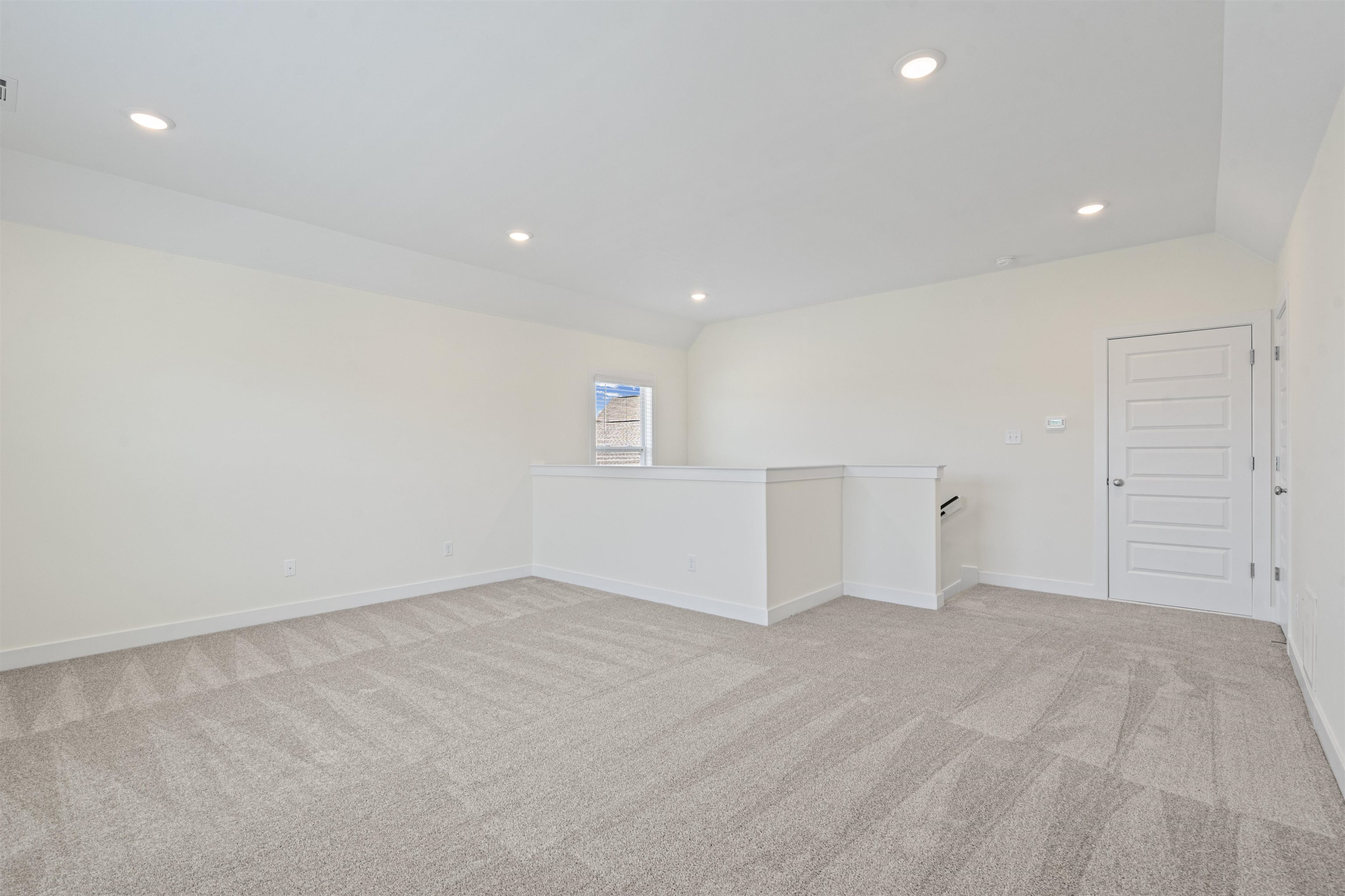 5666 Pleasant Pk Place Arlington, TN 38002 - Photo 23 of 27 Expansive carpeted room featuring a white interior, recessed lighting, a vaulted ceiling, a small window, and a five-panel interior door